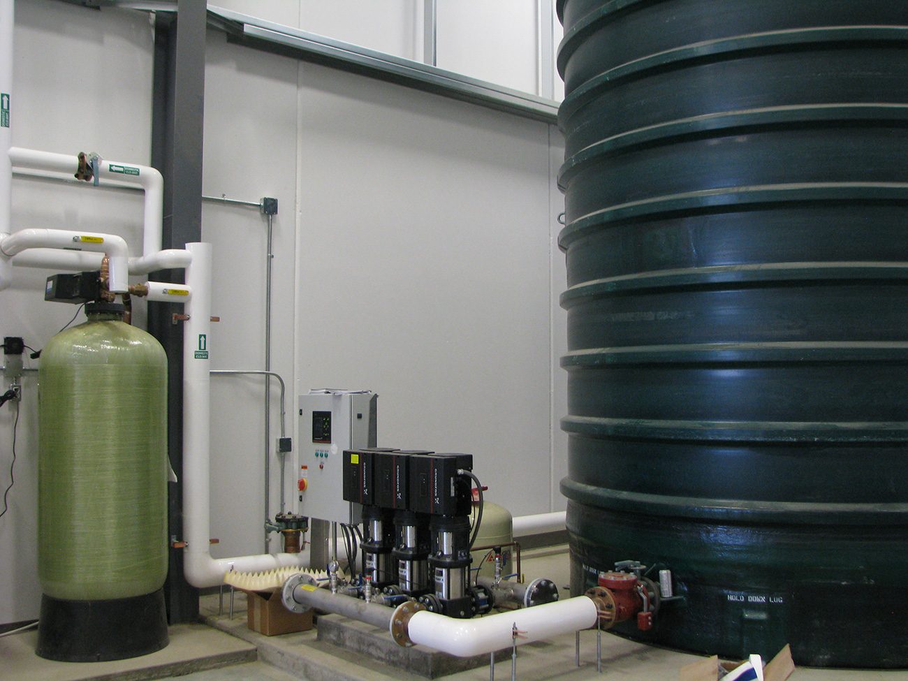 Water treatment system with storage tank and pumps